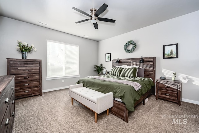 bedroom with carpet, visible vents, ceiling fan, and baseboards