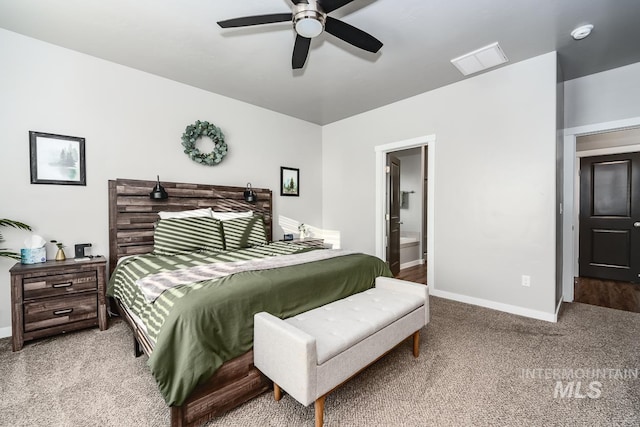 bedroom with carpet floors, visible vents, a ceiling fan, ensuite bath, and baseboards