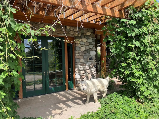 1262 N Soldier Creek Rd, Fairfield, ID 83327 - entrance to property featuring a pergola, french doors, and stone siding