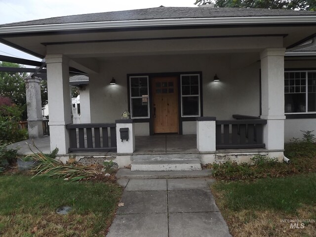 doorway to property with a porch