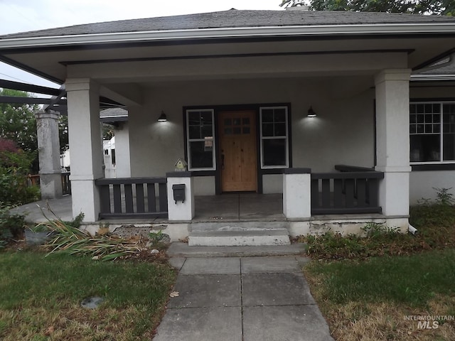 view of exterior entry featuring a porch