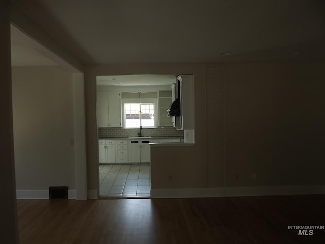 spare room featuring sink and light hardwood / wood-style flooring