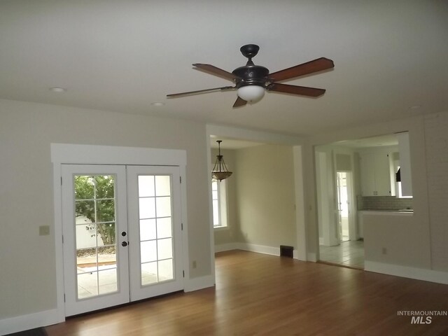 interior space featuring ceiling fan, light wood-type flooring, and french doors