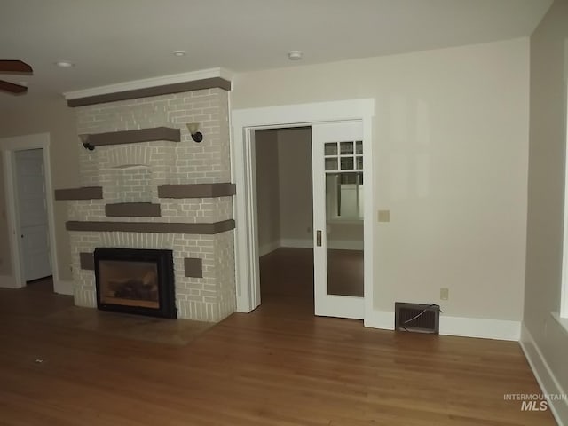 unfurnished living room featuring hardwood / wood-style flooring and a fireplace