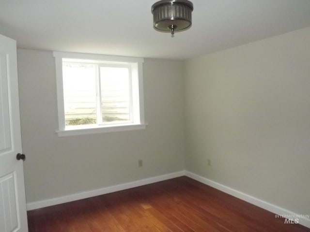 empty room featuring dark hardwood / wood-style flooring