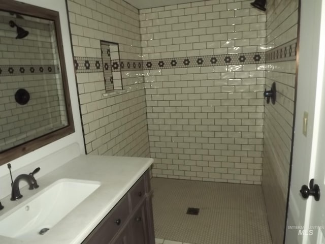 bathroom featuring vanity and tiled shower