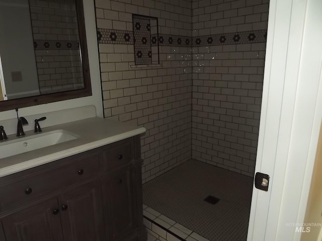 bathroom featuring vanity and a tile shower