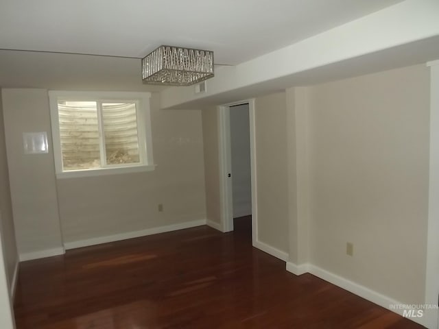 empty room with dark hardwood / wood-style flooring