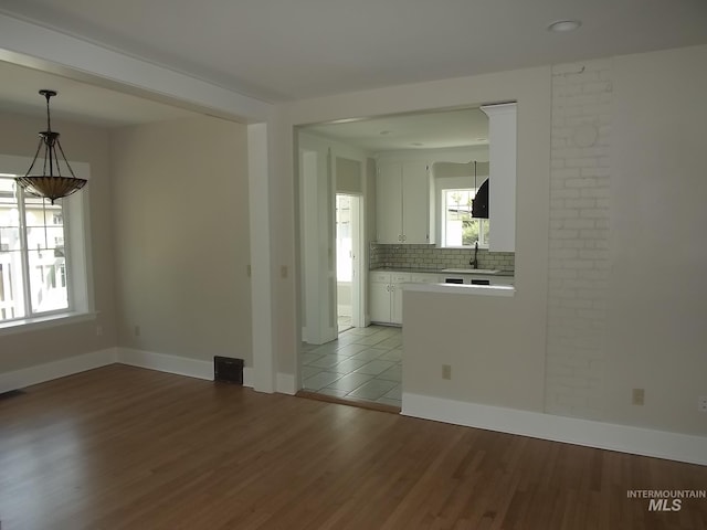 empty room with sink and hardwood / wood-style floors