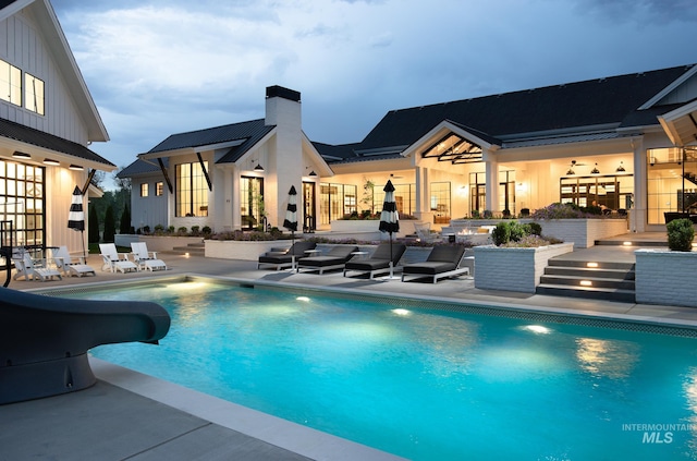 view of pool featuring a patio and a water slide