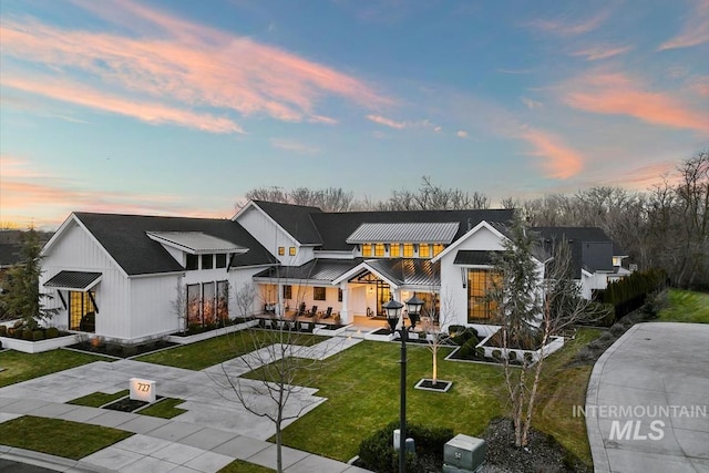 modern farmhouse featuring a yard and a patio area