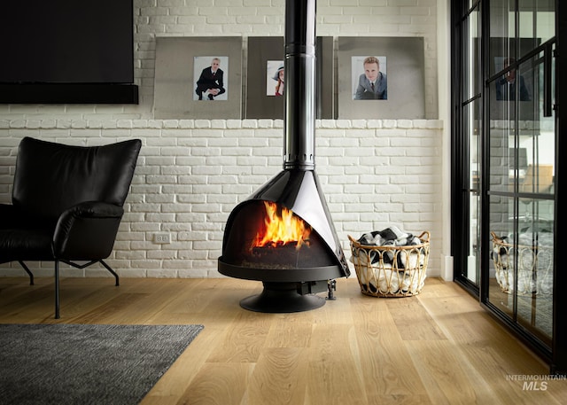 room details featuring a wood stove and wood-type flooring