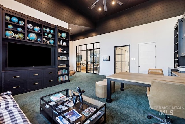 carpeted living room with a towering ceiling, wood ceiling, and ceiling fan