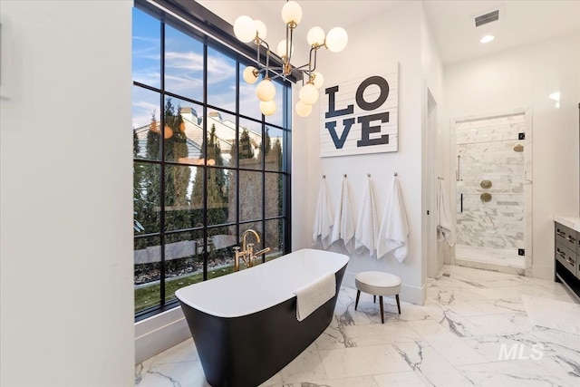 bathroom with vanity, a notable chandelier, plus walk in shower, and plenty of natural light