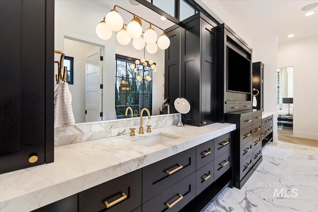 bathroom with vanity and a chandelier