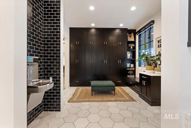 bathroom with tile patterned floors and tile walls