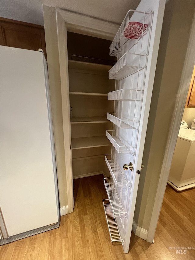 pantry featuring washing machine and clothes dryer