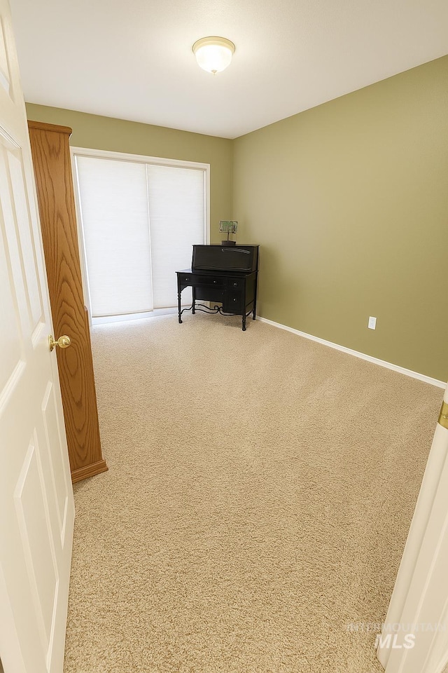 interior space featuring carpet floors and baseboards