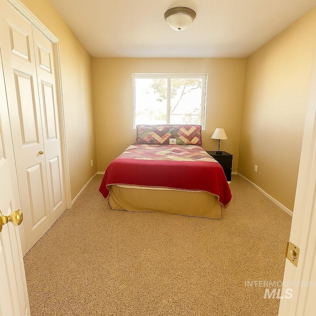 carpeted bedroom with baseboards