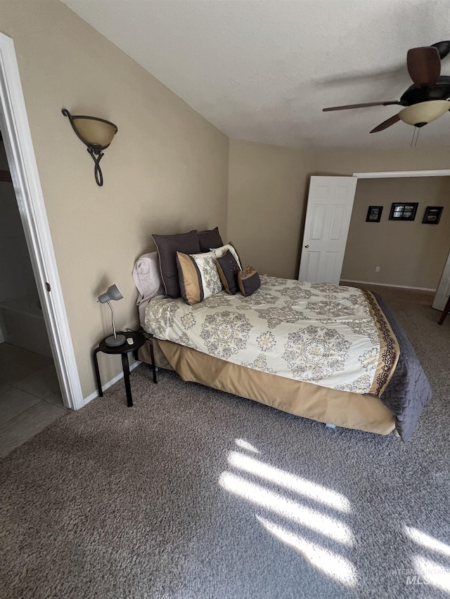 carpeted bedroom featuring a ceiling fan and baseboards