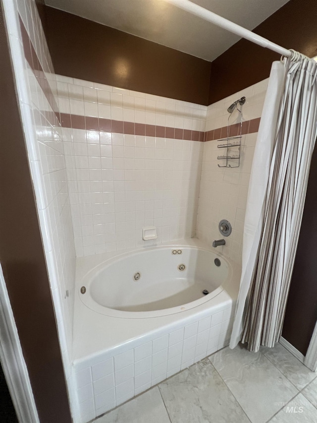 full bathroom featuring marble finish floor and a combined bath / shower with jetted tub