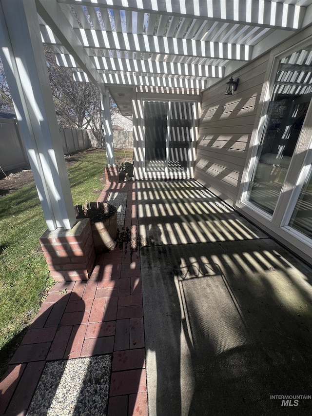view of patio / terrace featuring a pergola and fence