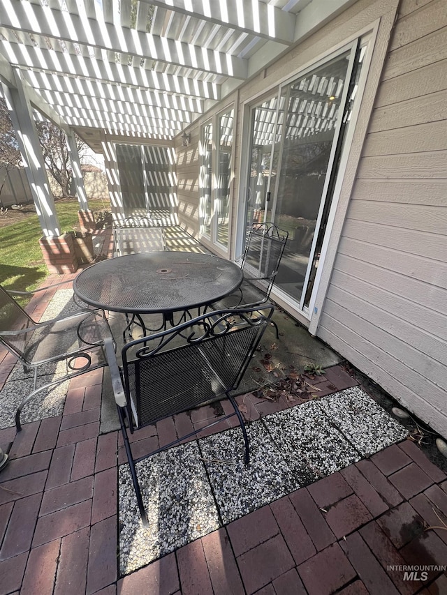 view of patio / terrace with a pergola and outdoor dining space