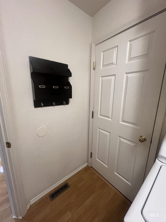 details with baseboards, visible vents, and wood finished floors