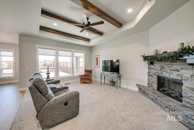 living room with recessed lighting, baseboards, beamed ceiling, ceiling fan, and a fireplace