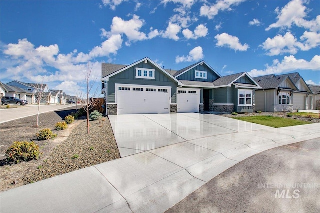 craftsman inspired home with stone siding, a garage, board and batten siding, and concrete driveway