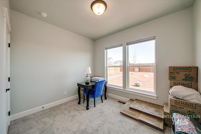 carpeted office space with baseboards