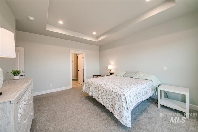 carpeted bedroom with a tray ceiling, baseboards, and recessed lighting