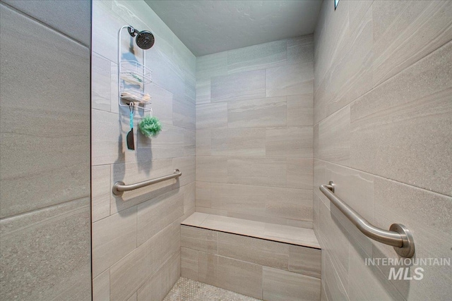 bathroom with tiled shower