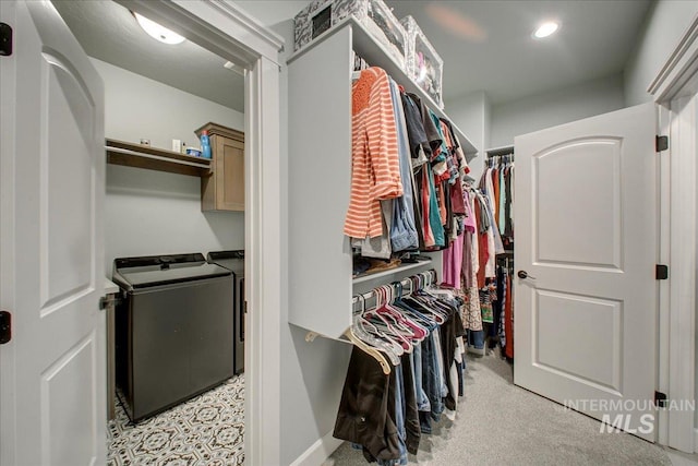 walk in closet featuring washing machine and dryer