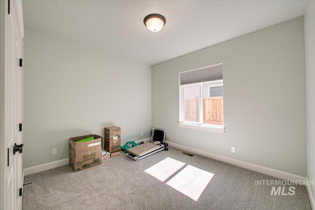 unfurnished room with baseboards, visible vents, and carpet floors
