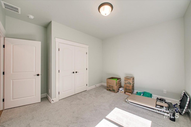 interior space with a closet, baseboards, and visible vents