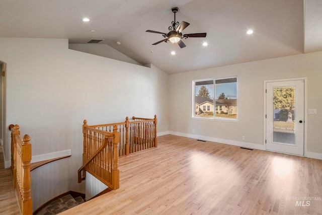 spare room with ceiling fan, light hardwood / wood-style floors, and vaulted ceiling