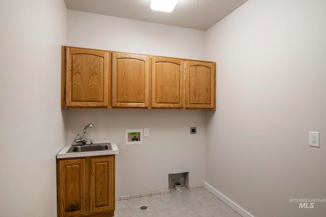 washroom with cabinets, washer hookup, electric dryer hookup, and sink