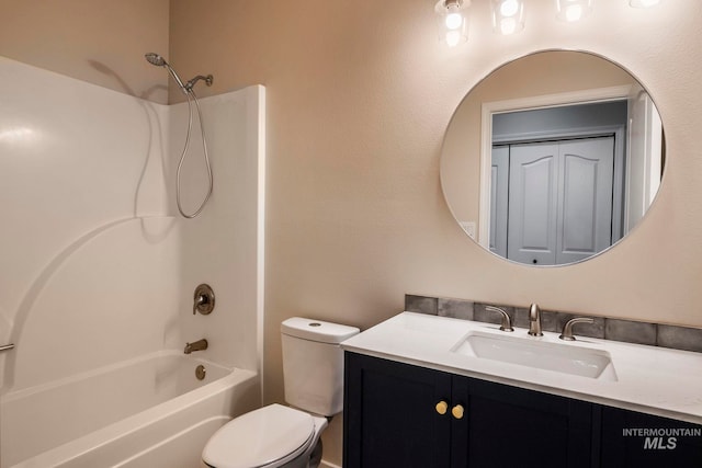 full bathroom featuring washtub / shower combination, vanity, and toilet