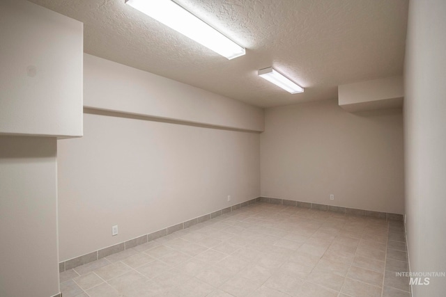 unfurnished room with a textured ceiling