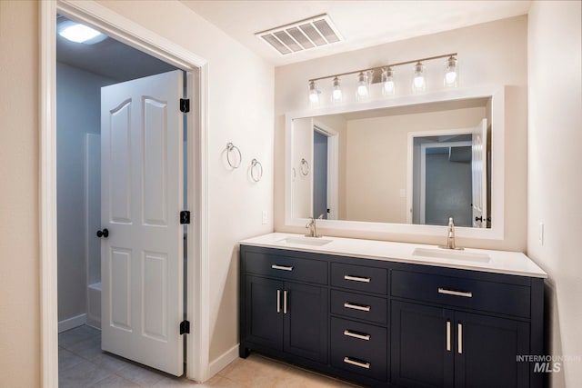 bathroom featuring tile patterned flooring and vanity