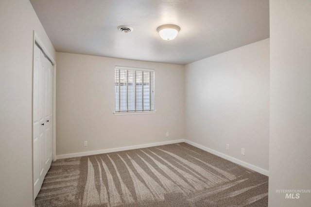 unfurnished room featuring carpet flooring