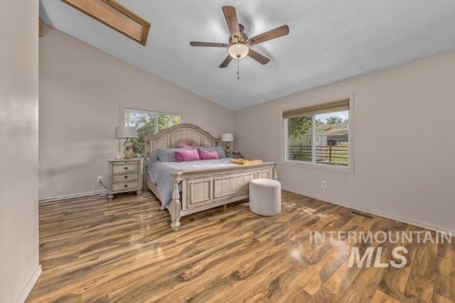 4610 Power Rd, Ontario, OR 97914 - bedroom with wood finished floors, multiple windows, baseboards, and lofted ceiling