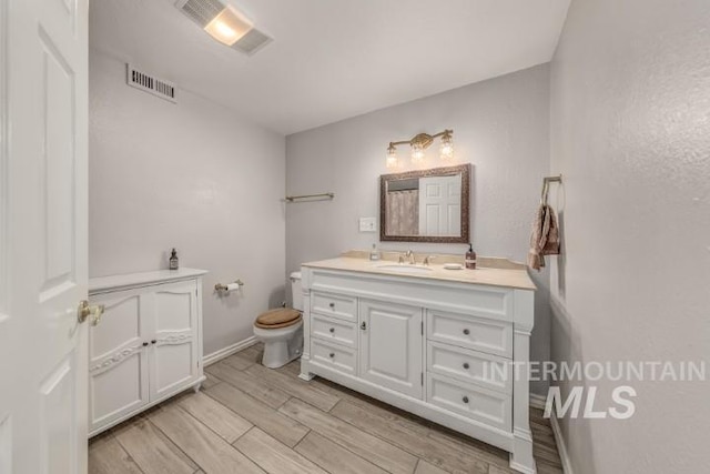 4610 Power Rd, Ontario, OR 97914 - bathroom featuring vanity, toilet, wood finished floors, and baseboards
