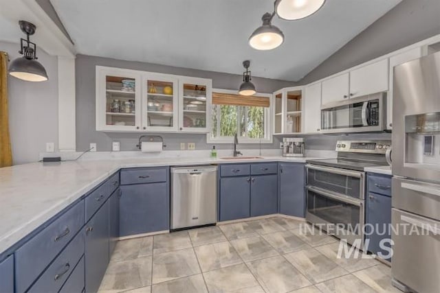 4610 Power Rd, Ontario, OR 97914 - kitchen featuring stainless steel appliances, a sink, vaulted ceiling, white cabinets, and light countertops