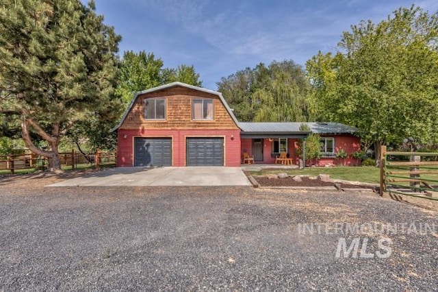 4610 Power Rd, Ontario, OR 97914 - colonial inspired home featuring a gambrel roof, covered porch, concrete driveway, and an attached garage