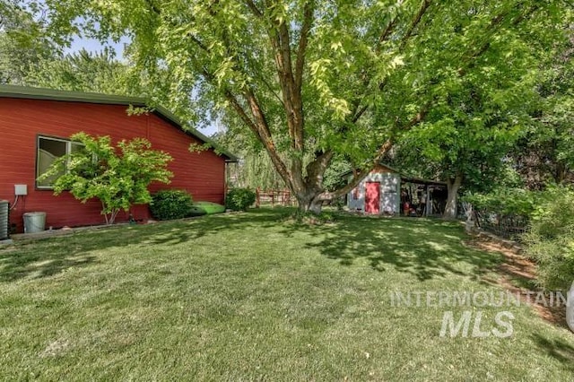 4610 Power Rd, Ontario, OR 97914 - view of green lawn featuring an outdoor structure and central AC unit