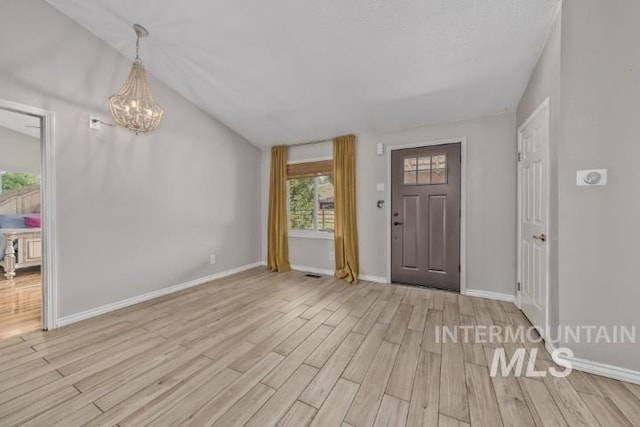 4610 Power Rd, Ontario, OR 97914 - entrance foyer featuring light wood-type flooring, a chandelier, vaulted ceiling, and baseboards