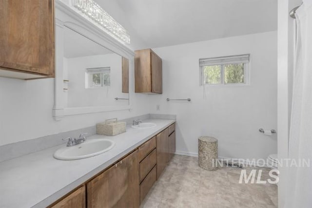 4610 Power Rd, Ontario, OR 97914 - bathroom featuring double vanity, toilet, and baseboards