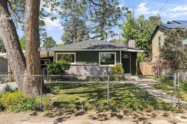 bungalow featuring brick siding, a chimney, and roof with shingles